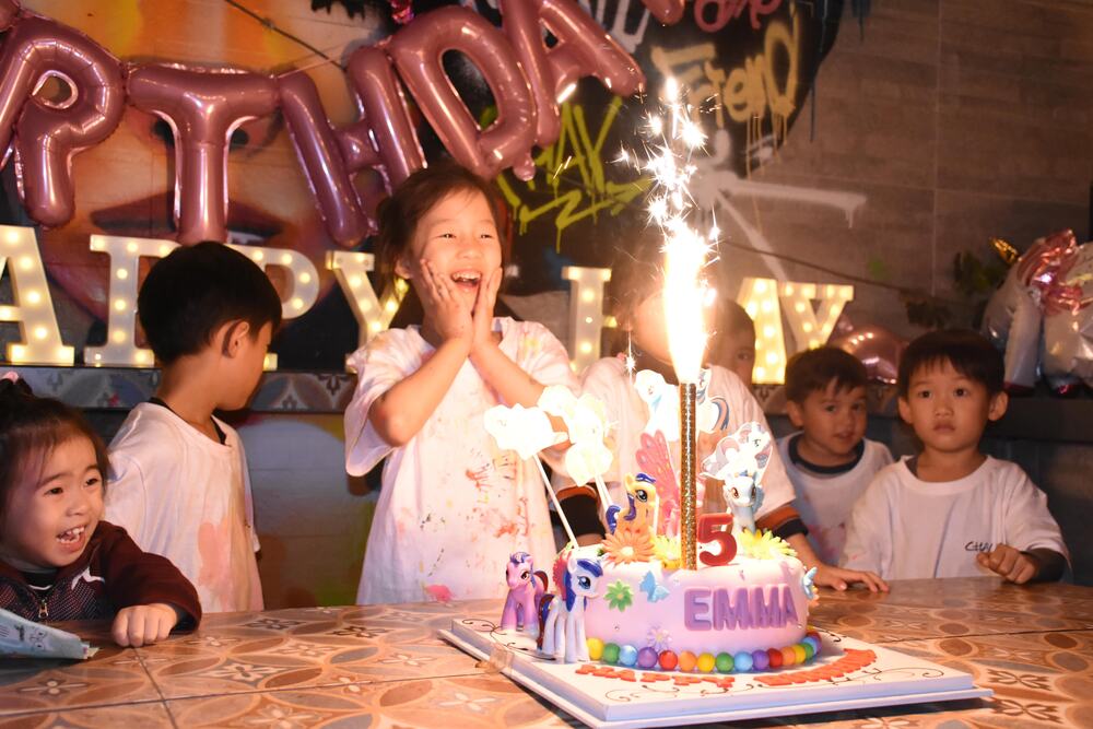 Children watching a sparkler birthday candle